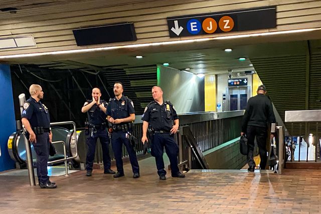 Officers standing together at Jamaica Center subway station.